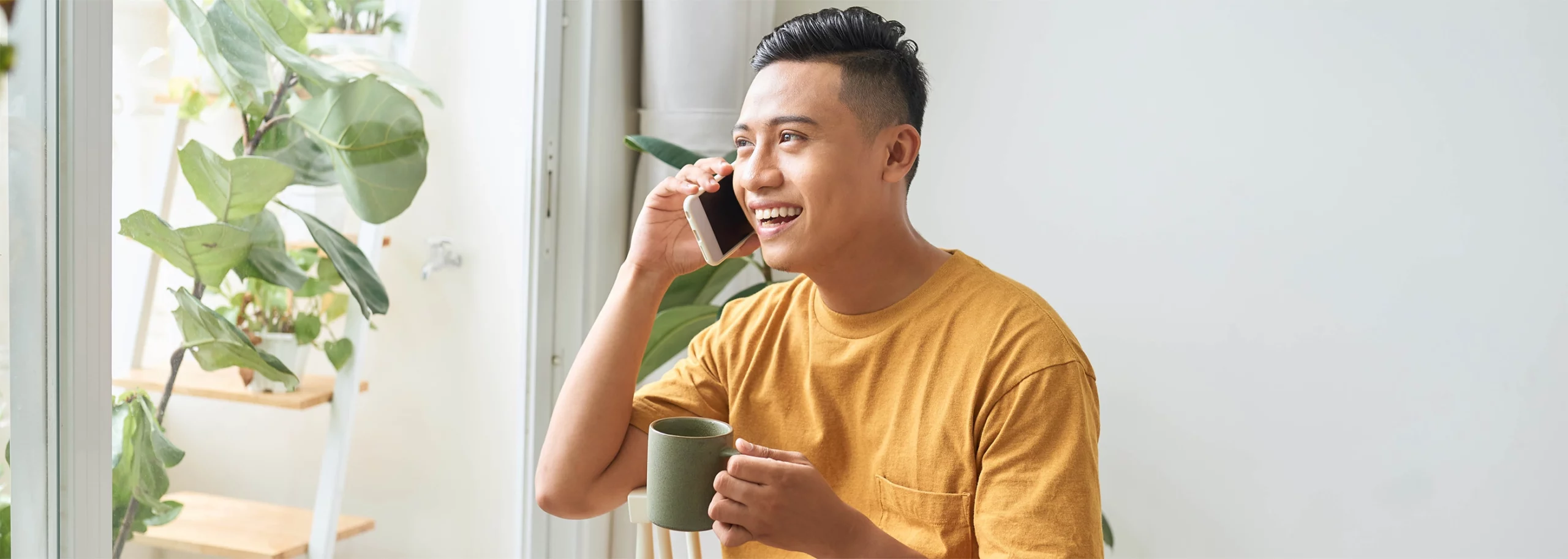 An Asian customer talking on a customer support helpline to resolve his issue