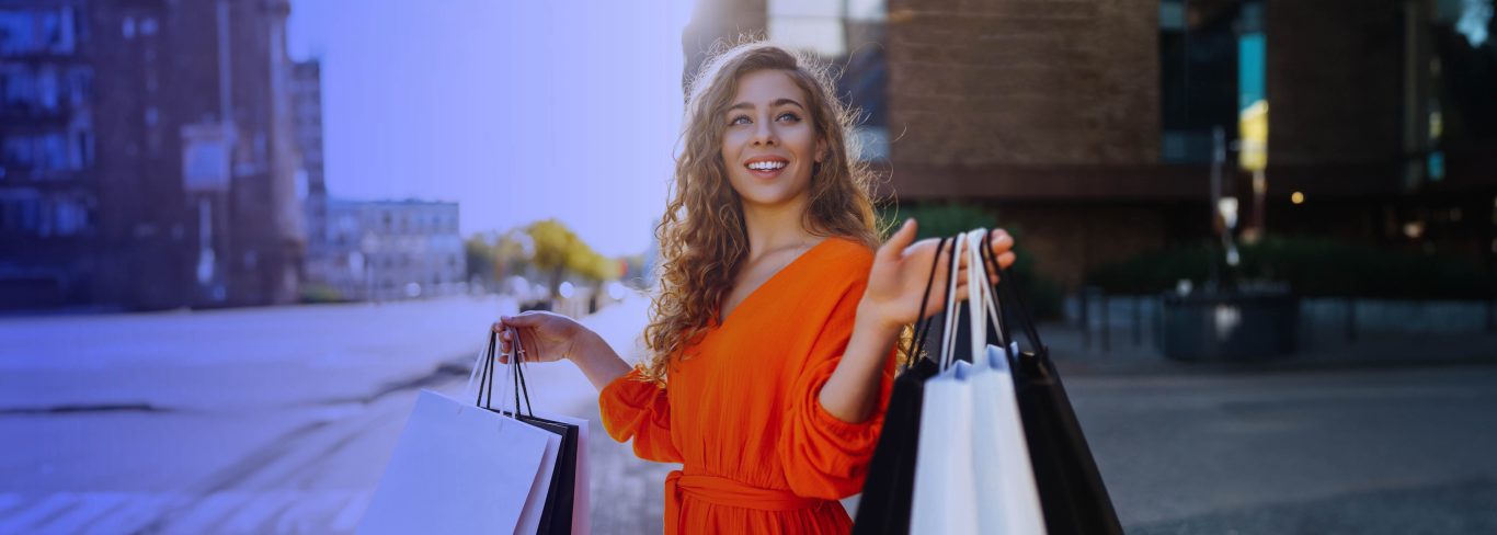 Happy young lady with shopping bags