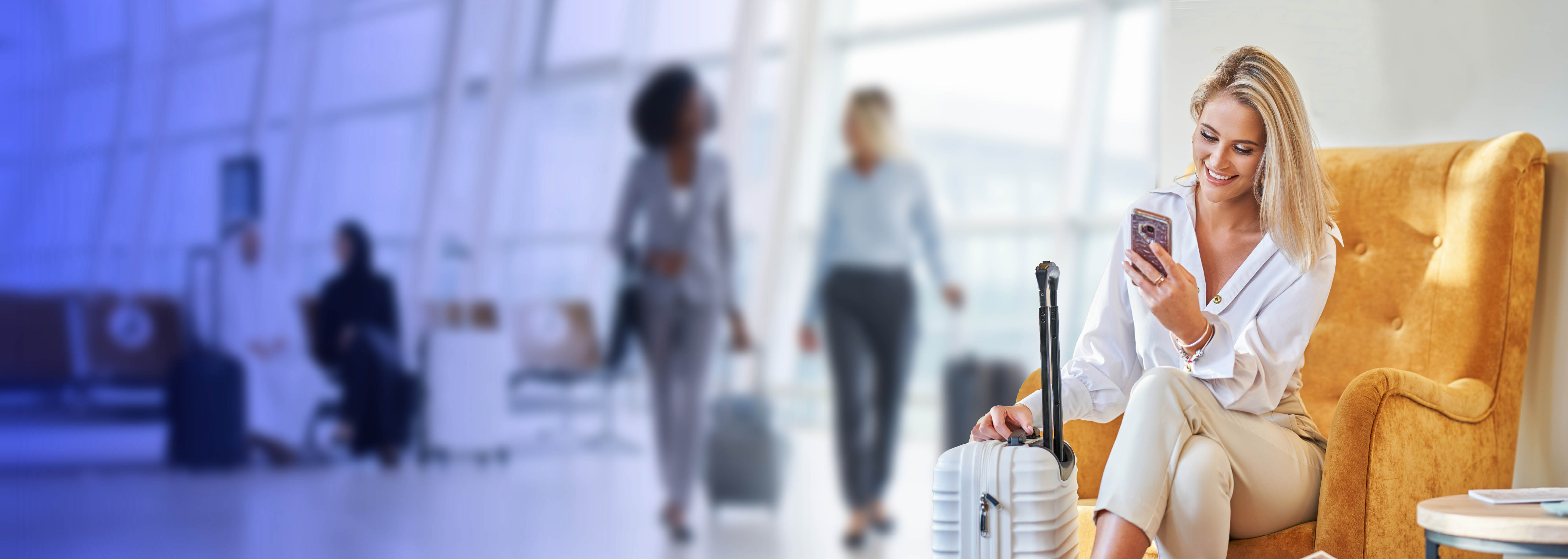 A woman at the airport enjoying the travel experience on her mobile