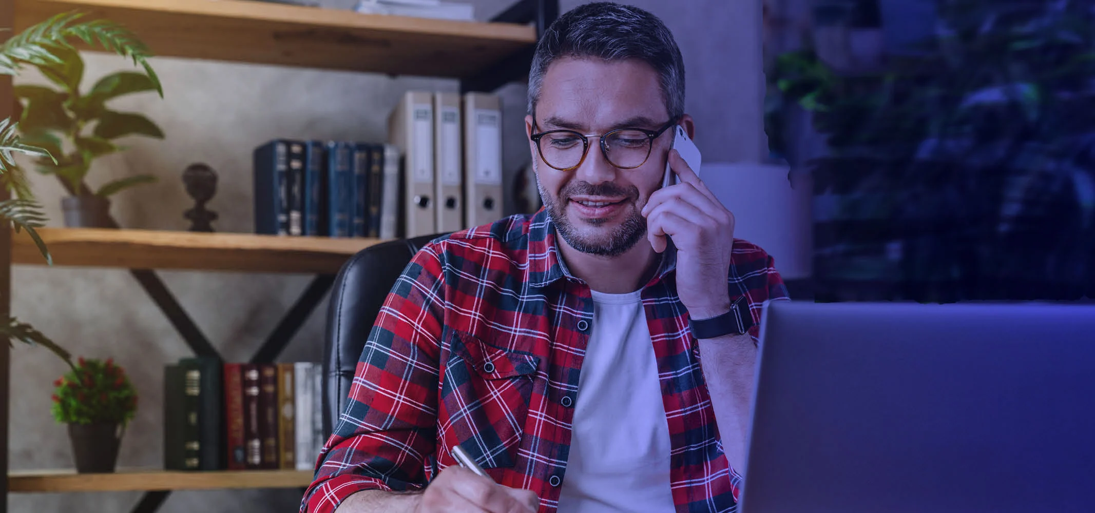 A happy middle age man speaking to a customer support executive on the phone