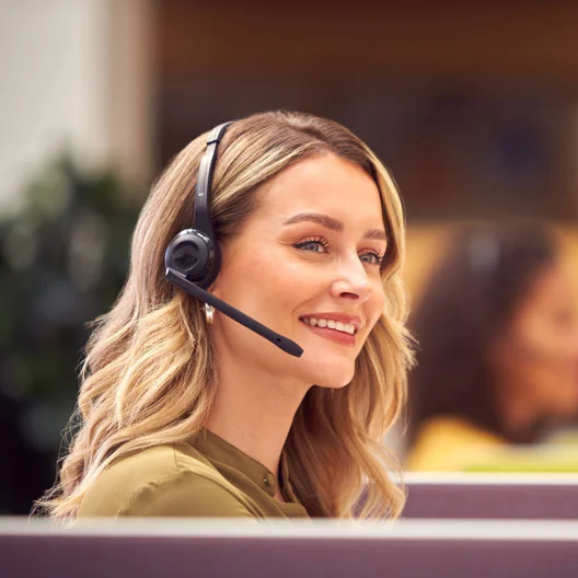 A happy customer service agent talking to a customer