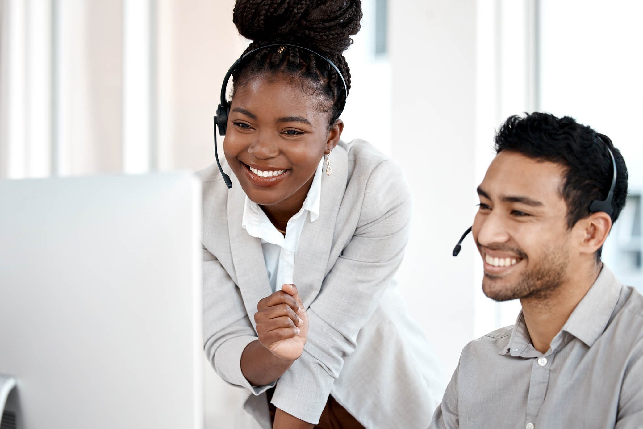 Two call center colleagues assisting each other