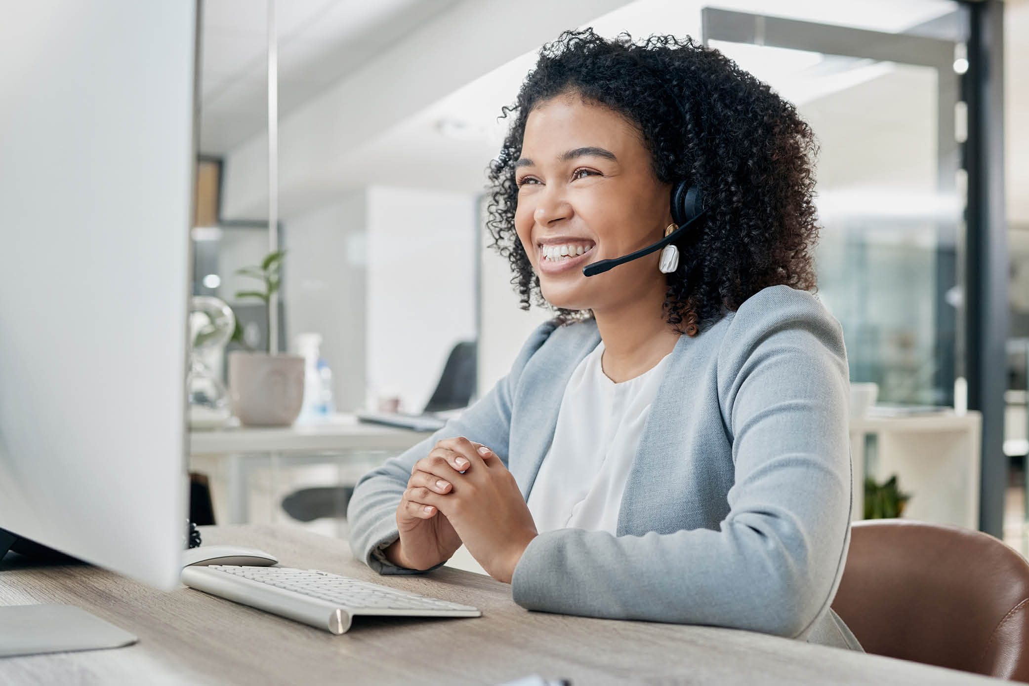 Call center agent happily addresses a customer