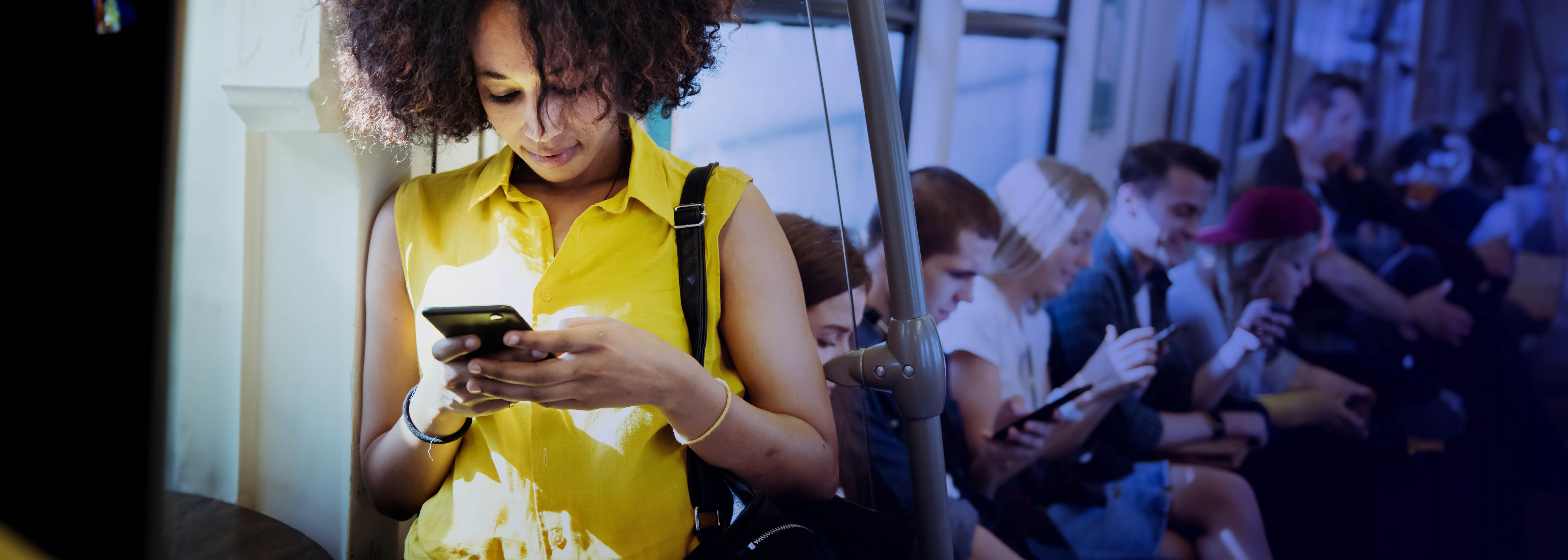 Young African lady browsing social media on her cellphone