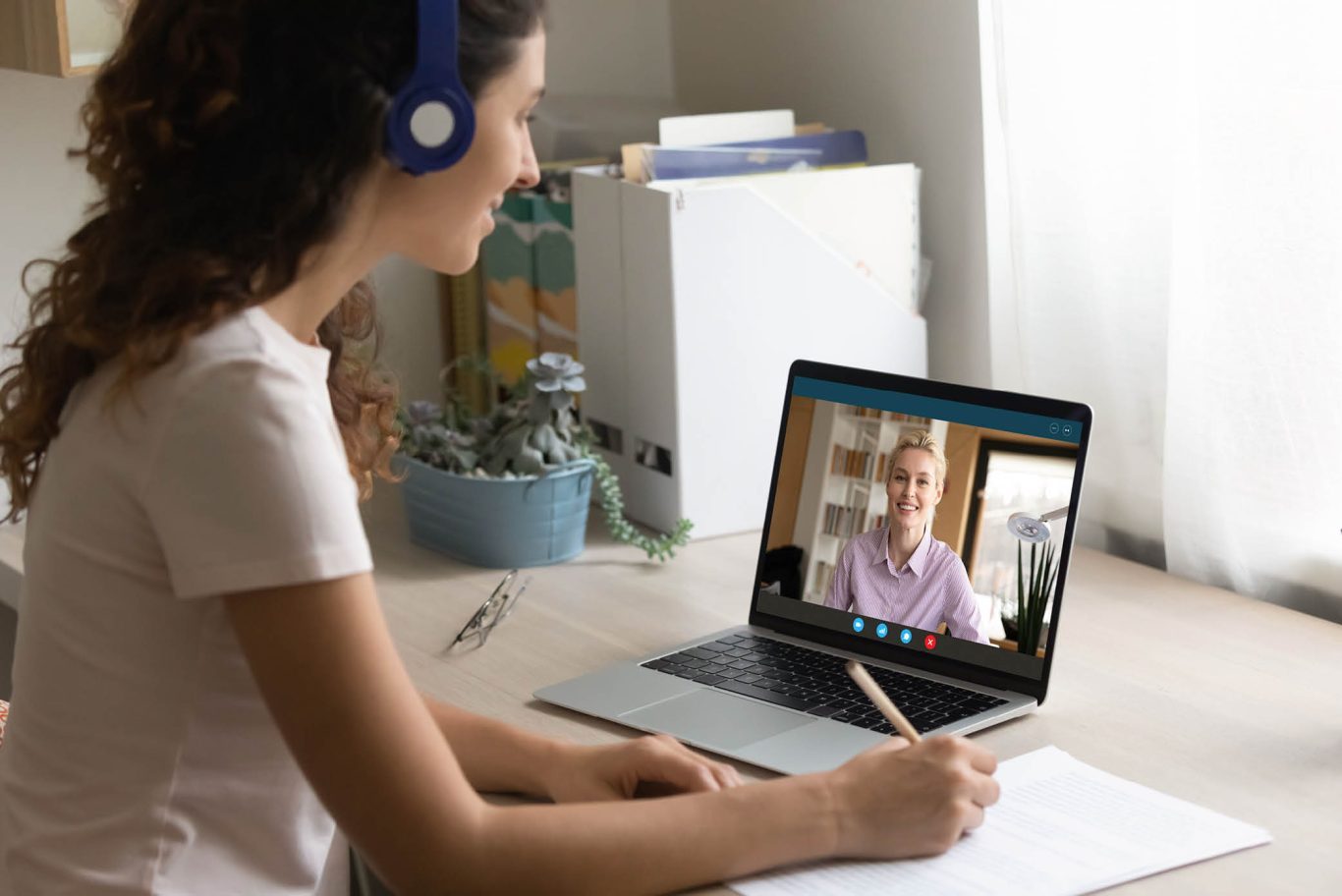 Smiling woman watch webinar on computer at home
