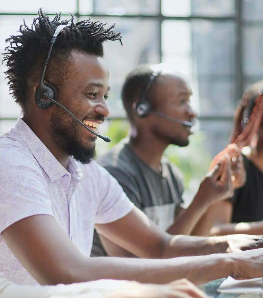 Happy agents in Africa working in a modern call center