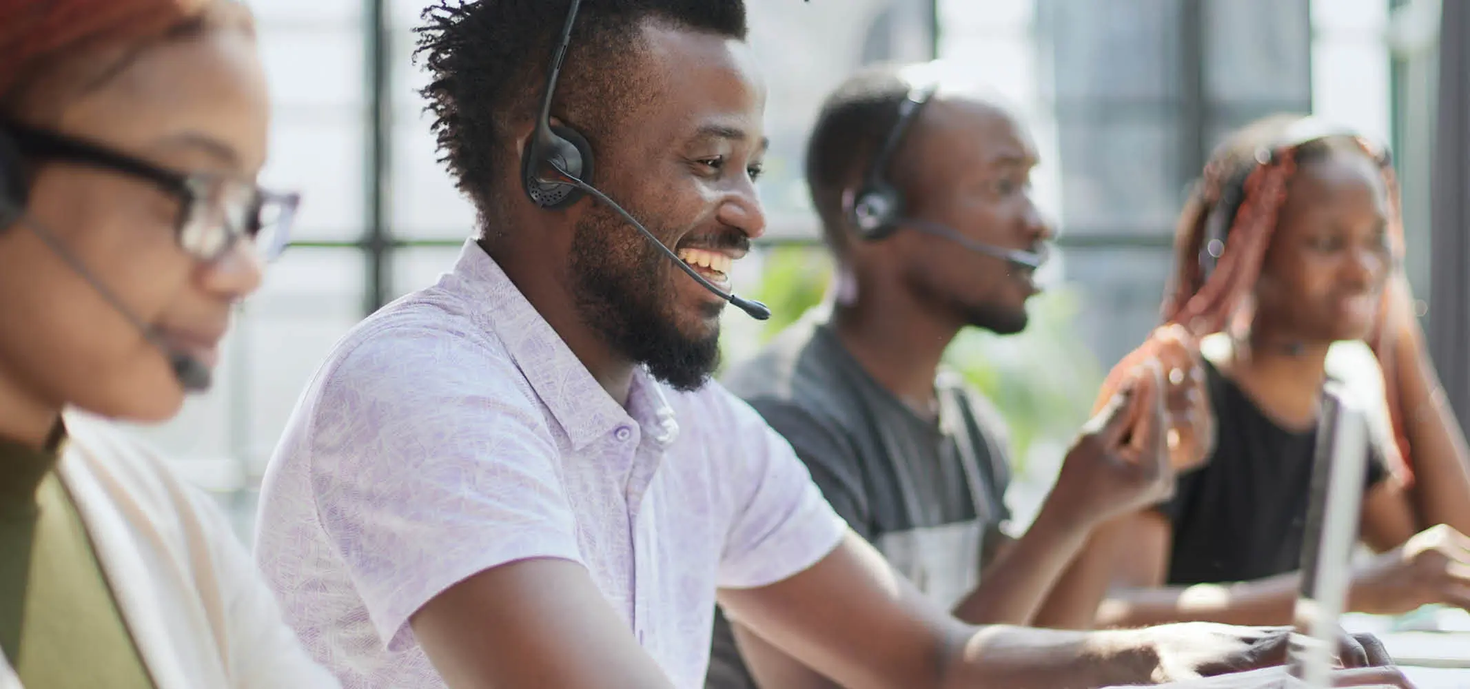 Happy agents in Africa working in a modern call center