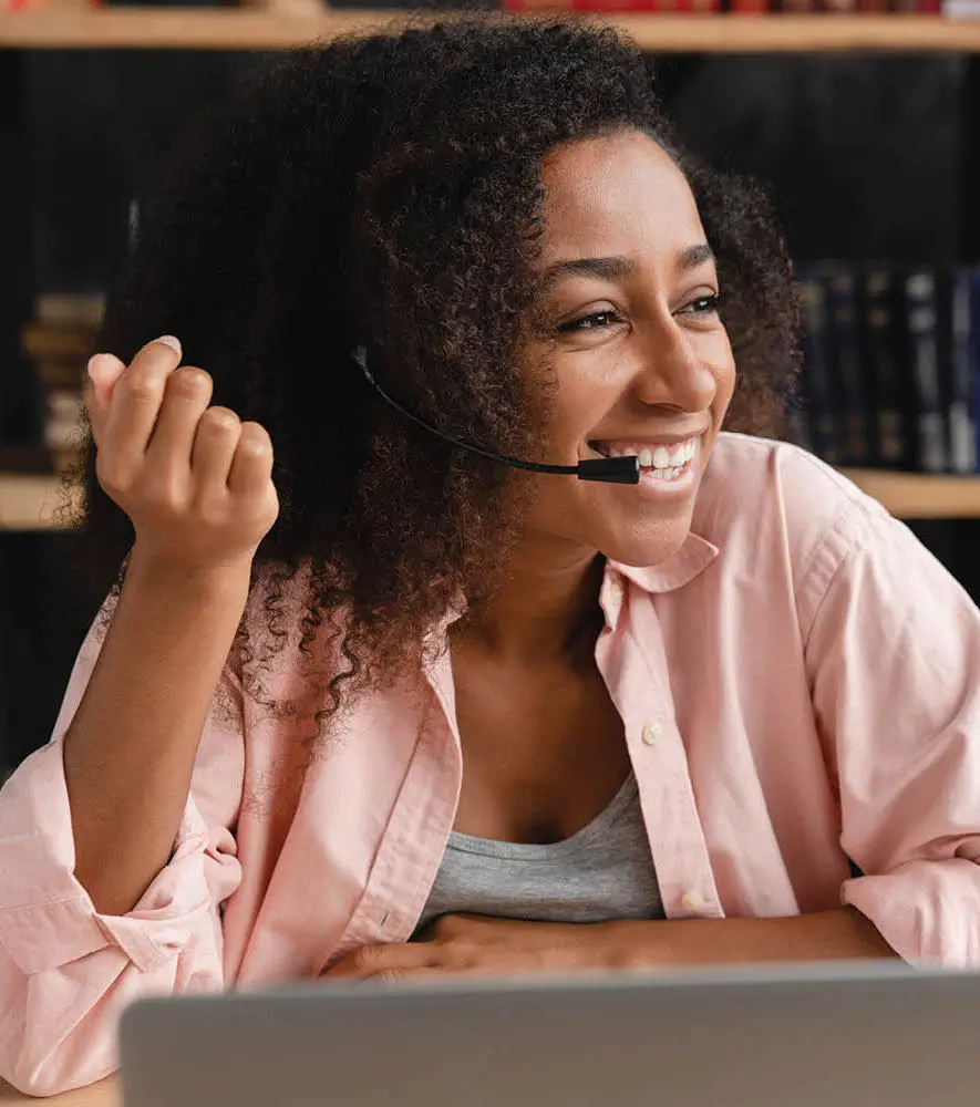 A happy call center agent speaking with the customer in a work from home set up