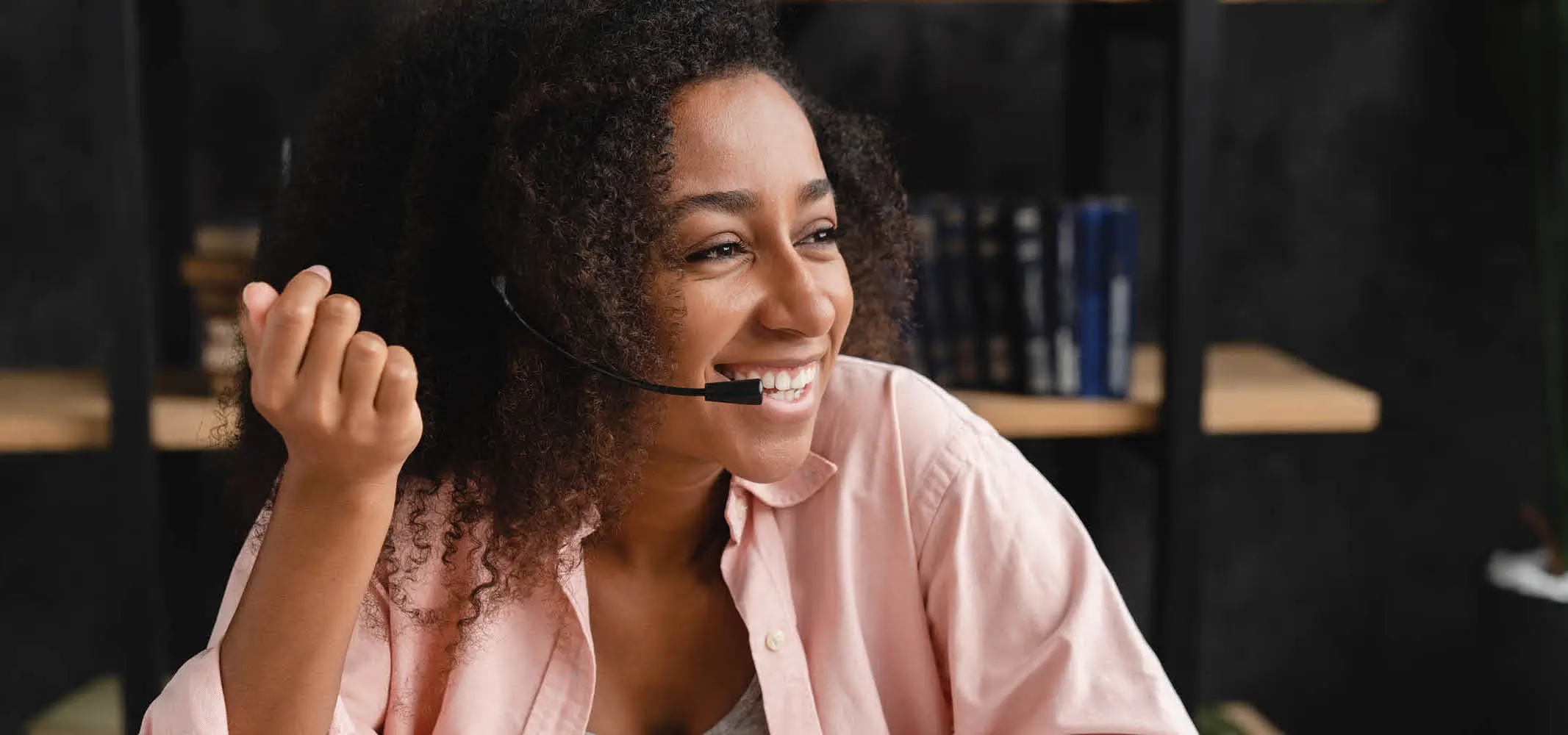 A happy call center agent speaking with the customer in a work from home set up
