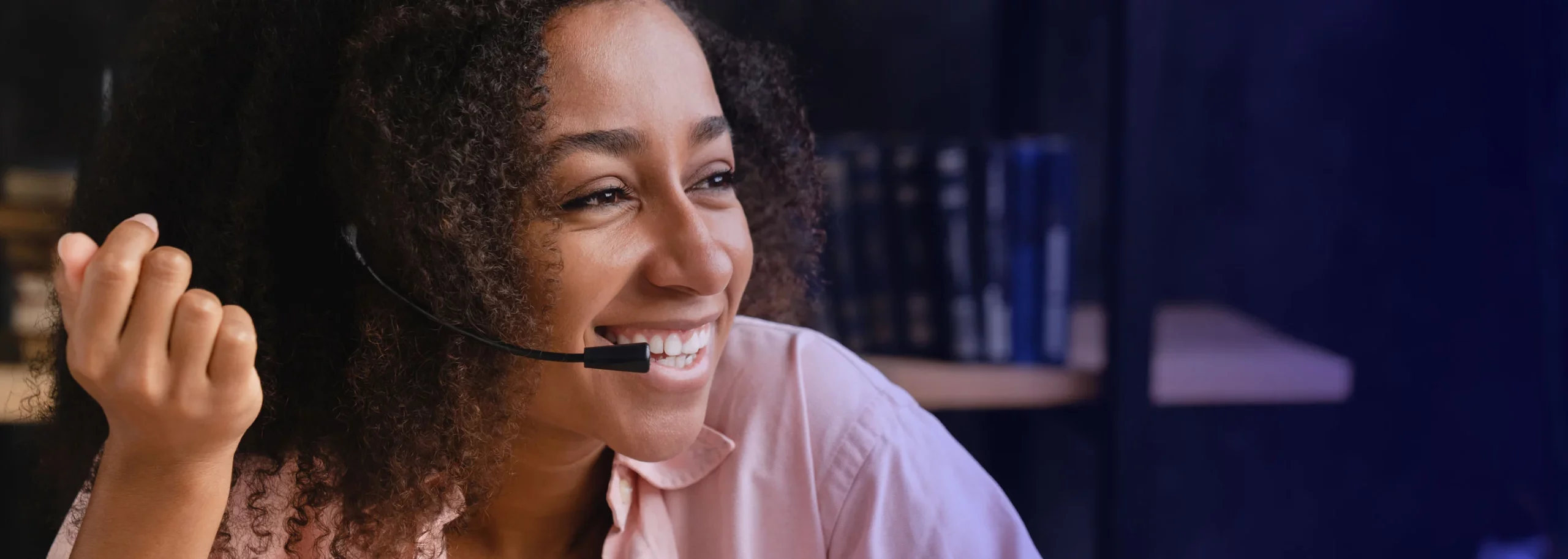 A happy call center agent speaking with the customer in a work from home set up