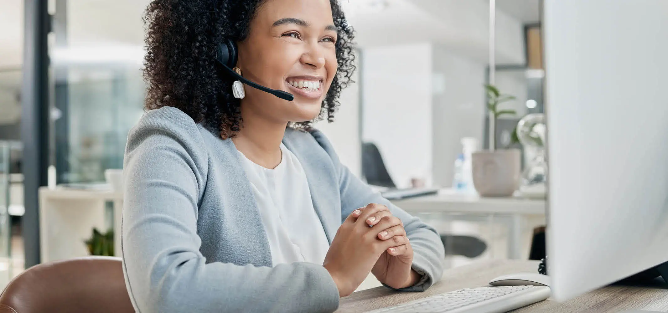 Female agent happy with automated quality management support in a call center