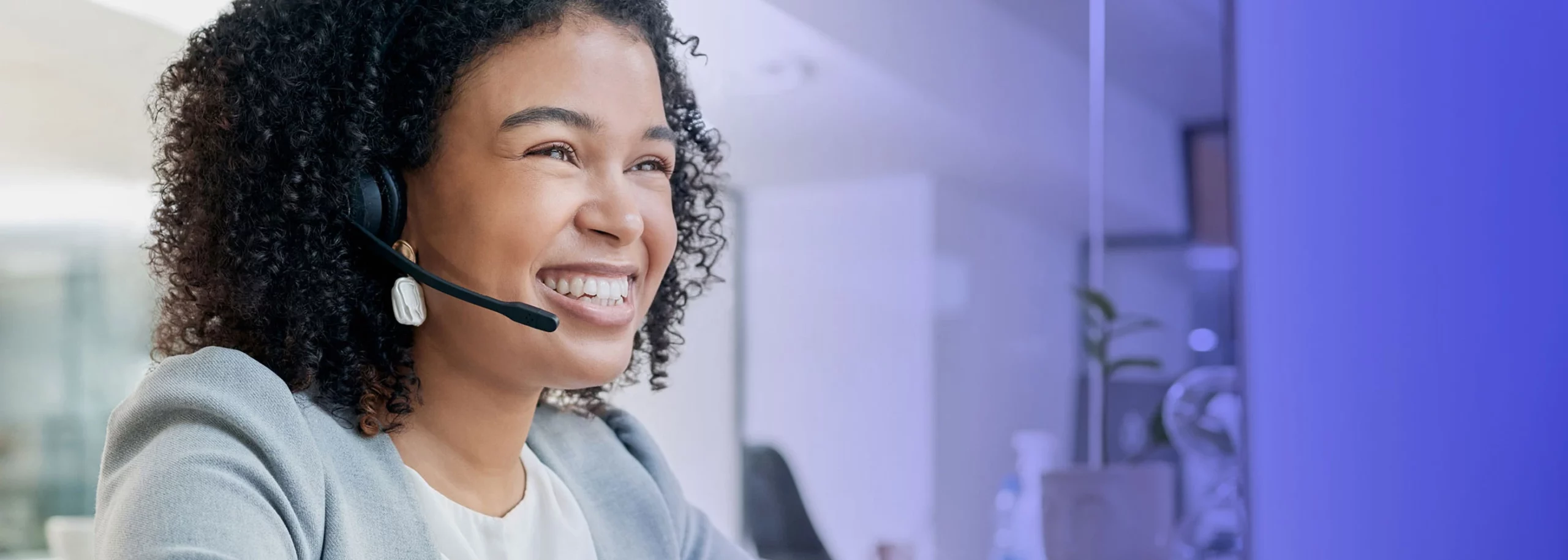 Female agent happy with automated quality management support in a call center