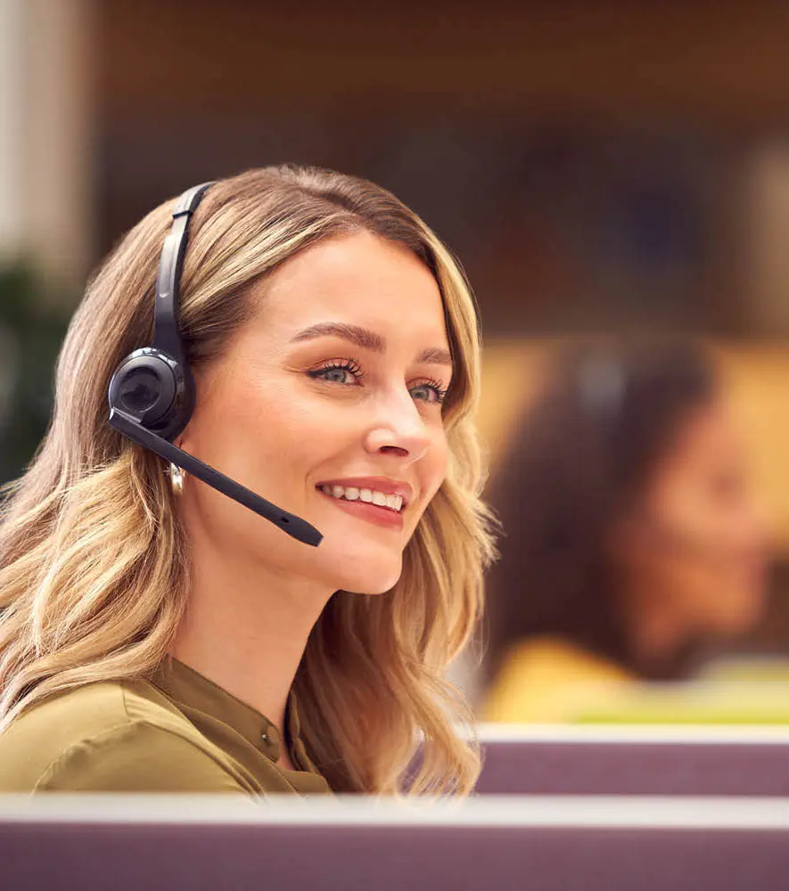A happy customer service agent talking to a customer