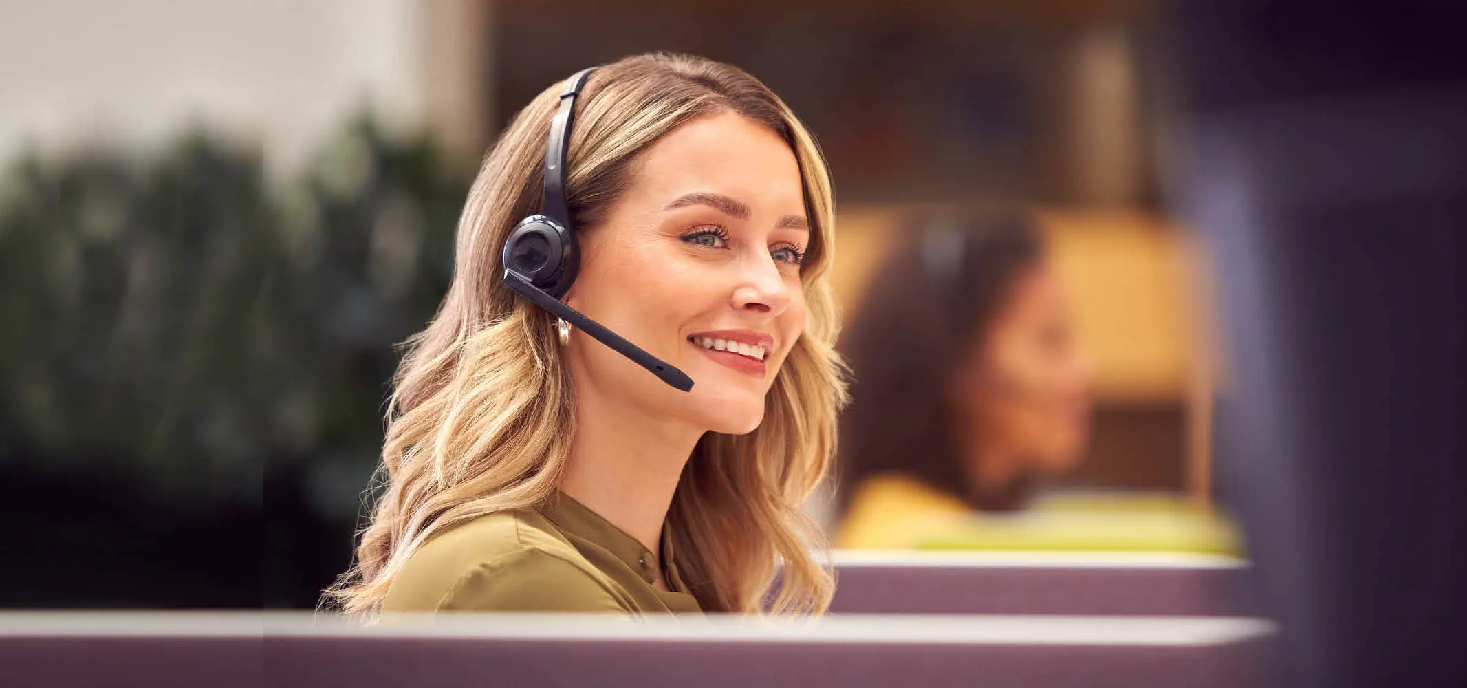 A happy customer service agent talking to a customer