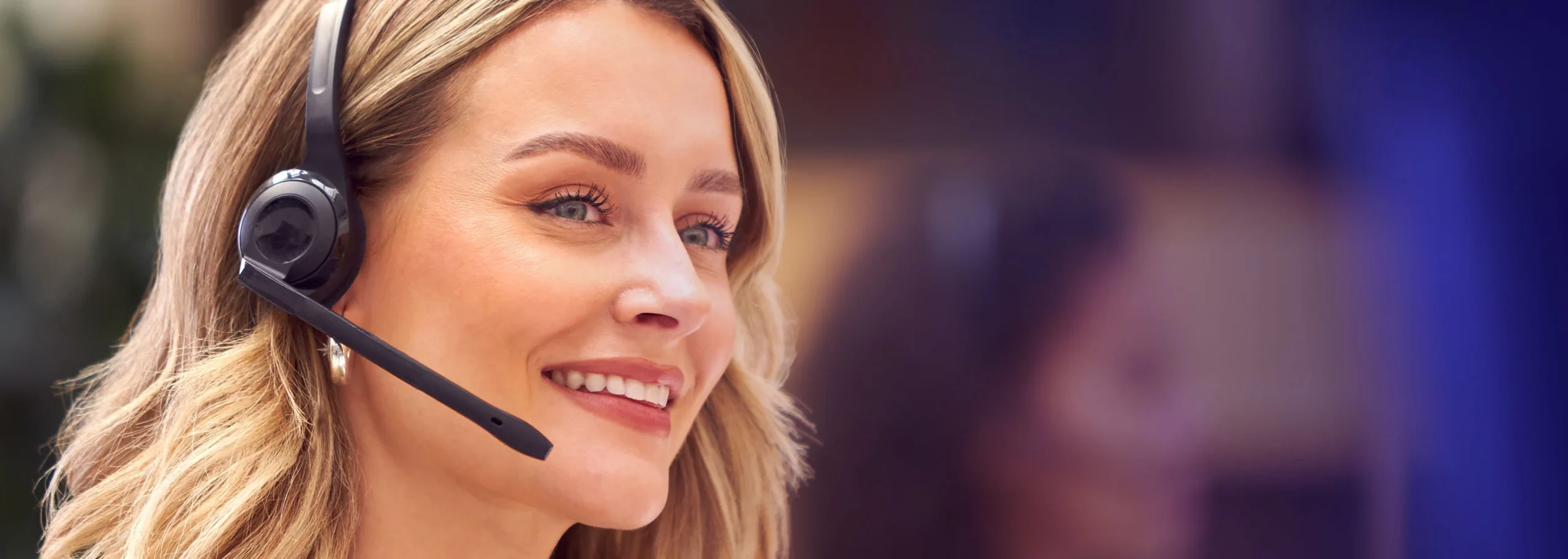 A happy customer service agent talking to a customer