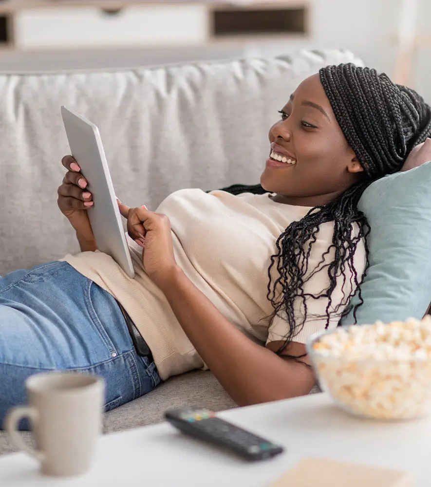 Happy woman browsing an online store through her tablet