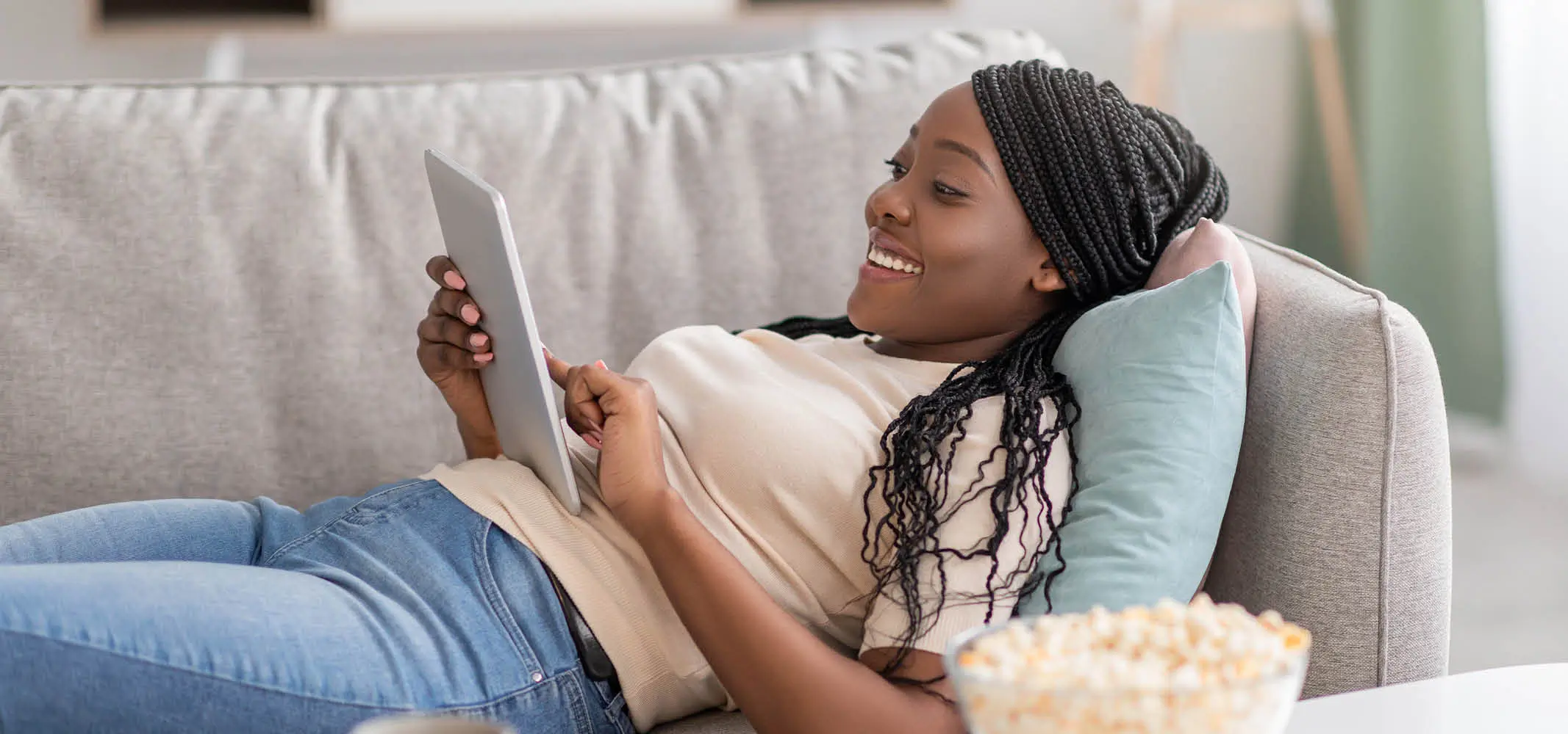 Happy woman browsing an online store through her tablet