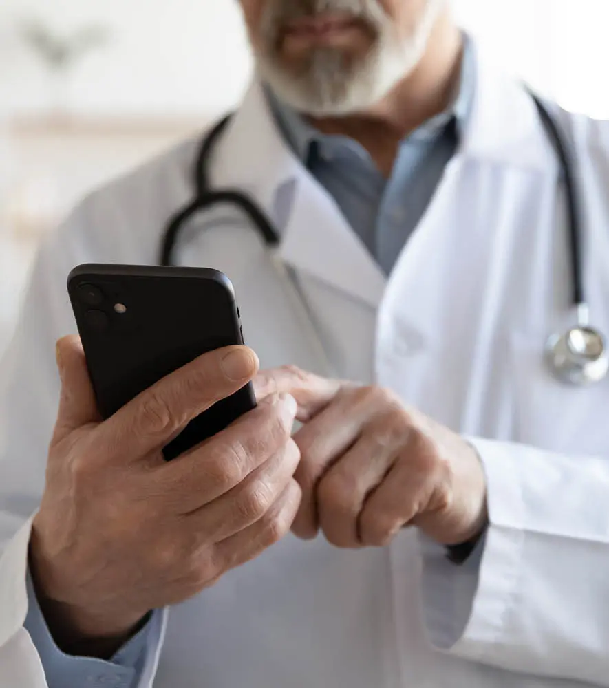 A doctor browsing through his mobile