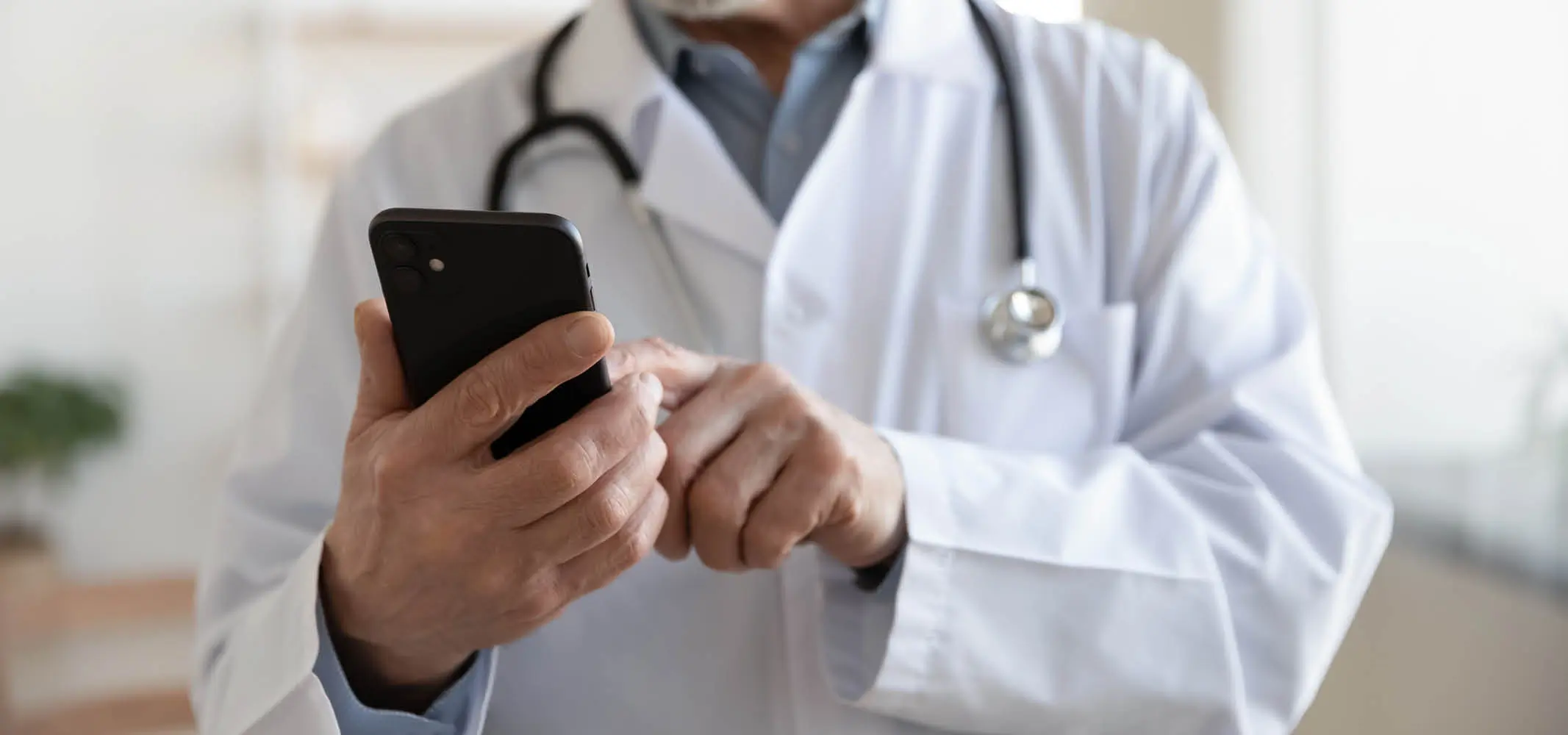 A doctor browsing through his mobile