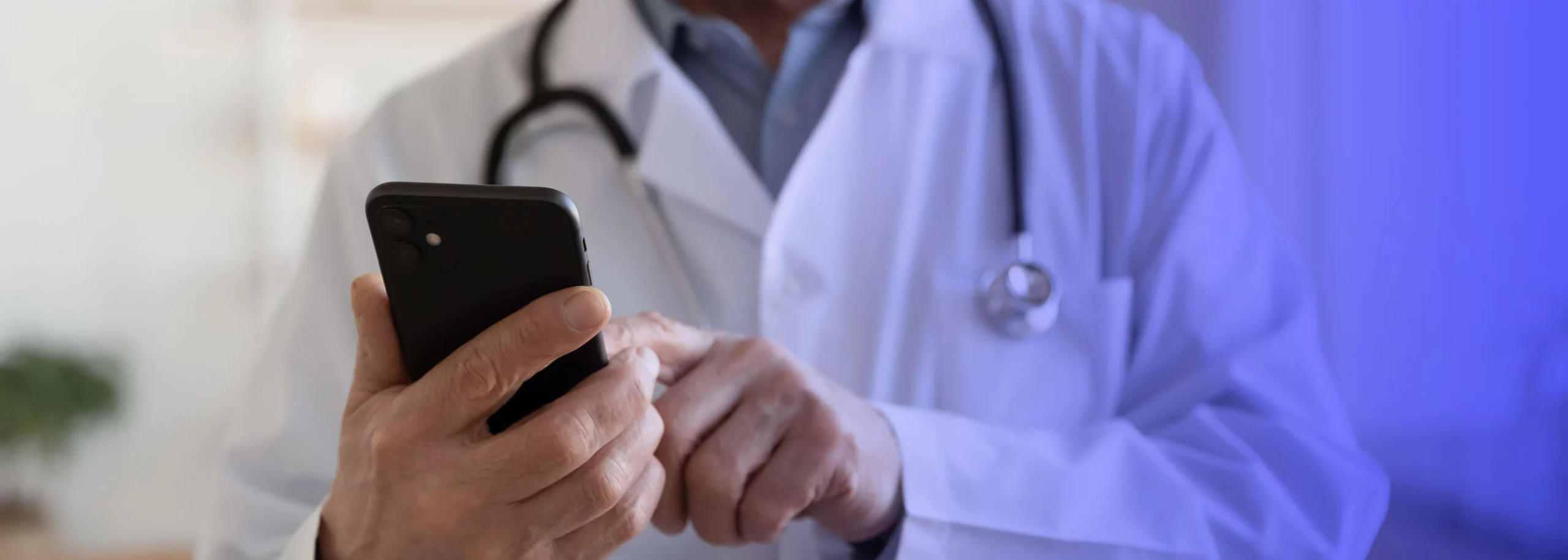 A doctor browsing through his mobile