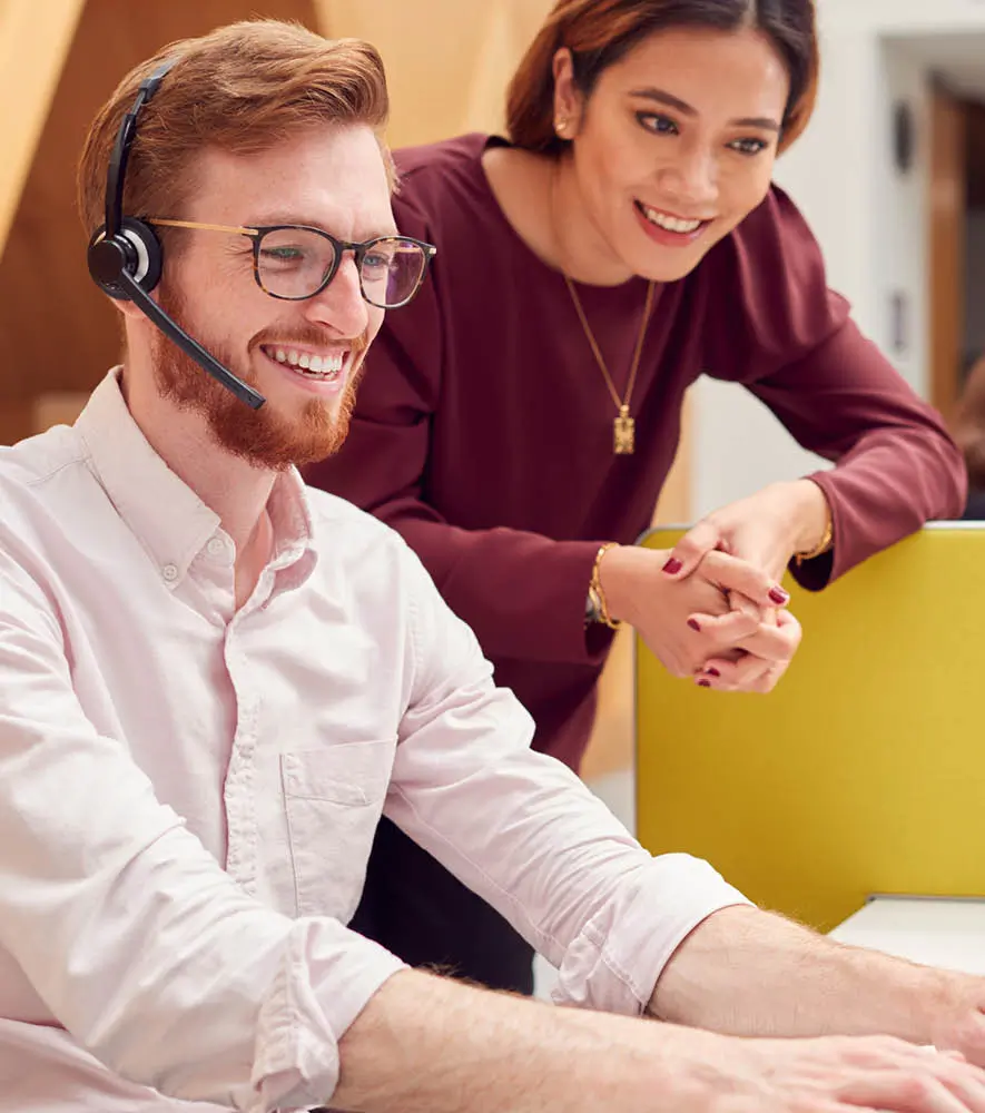 A call center leader coaching the newly hired agent