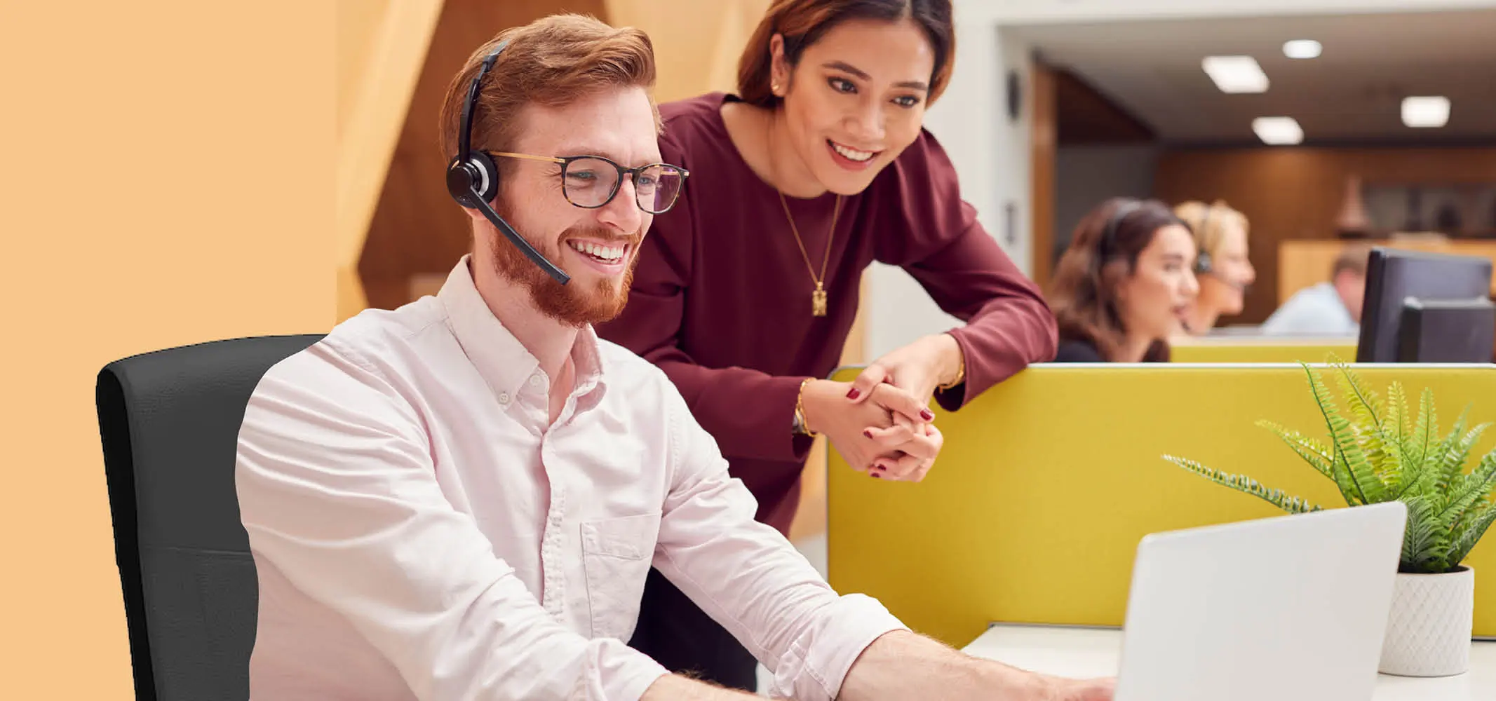 A call center leader coaching the newly hired agent