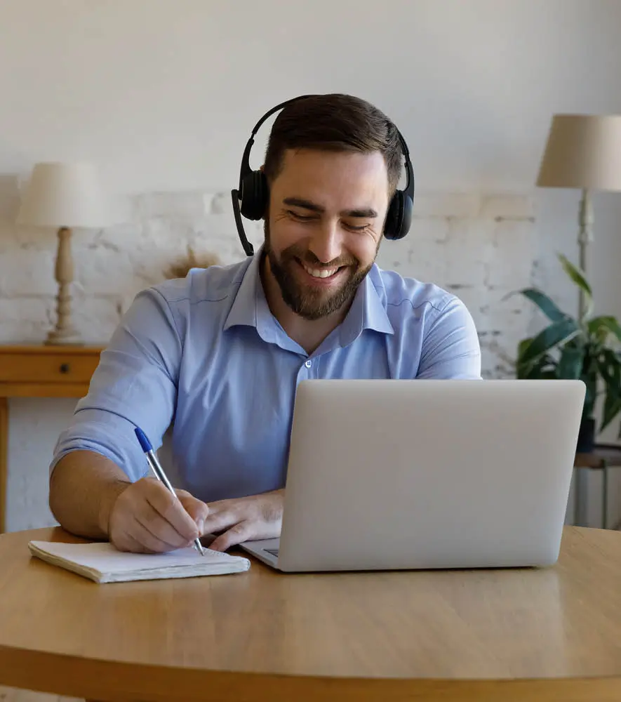 A happy agent speaking with the client from a work from home set up