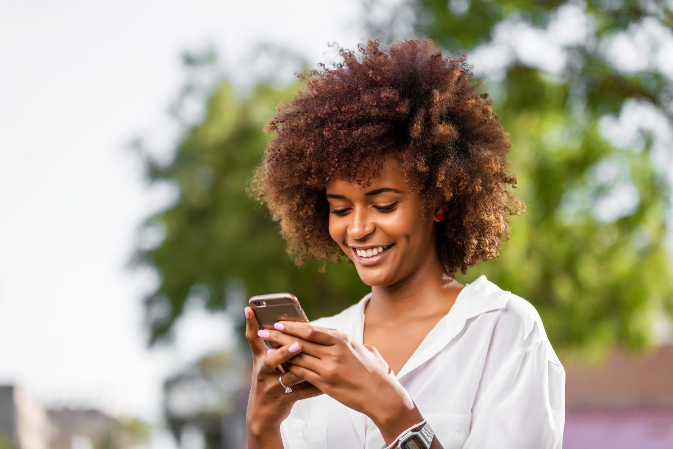 Young African girl using a chatbot on her mobile phone