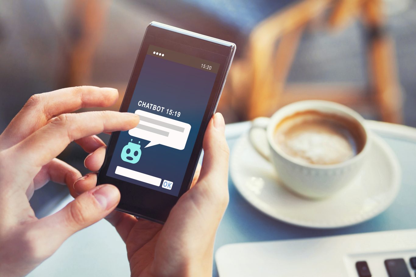person using a chatbot over a cup of coffee