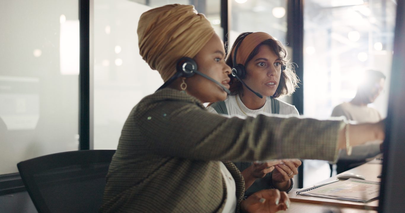 A manager trains a call center agent