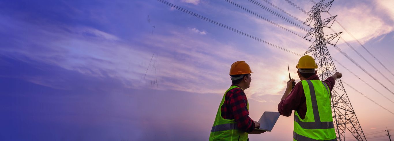 Two engineers observing a power tower